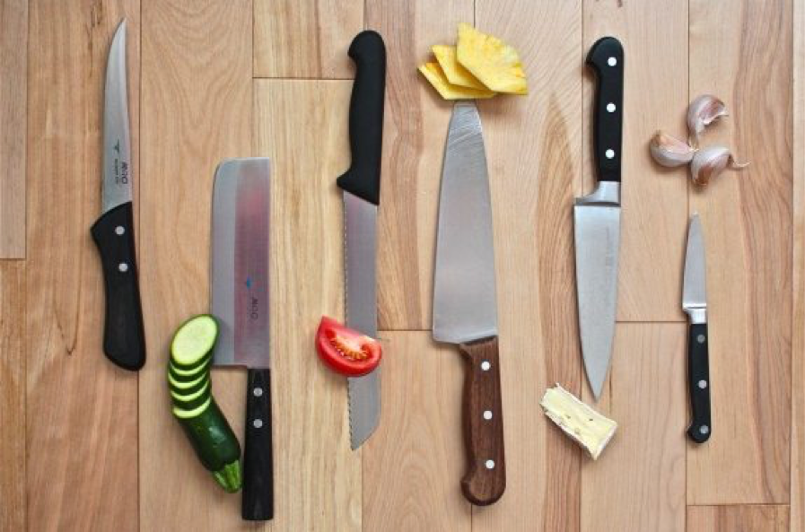 Kitchen knives with fruits and vegetables