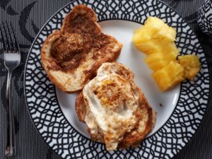 Breakfast plate with egg on toast and pineapple