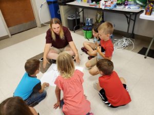 4H teen leader teaching younger children