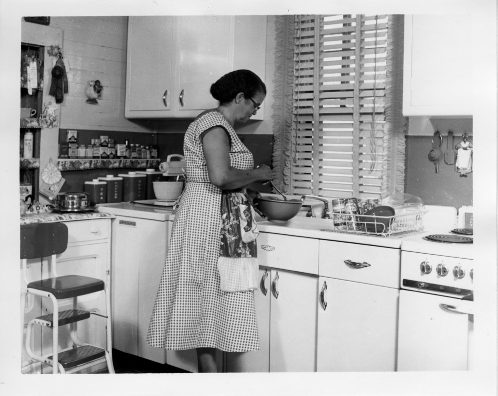 Demonstration agent in kitchen of African American demonstration home, 1956