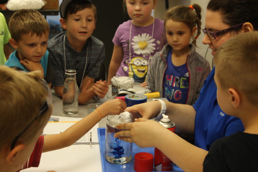 Kids watching a science experiment