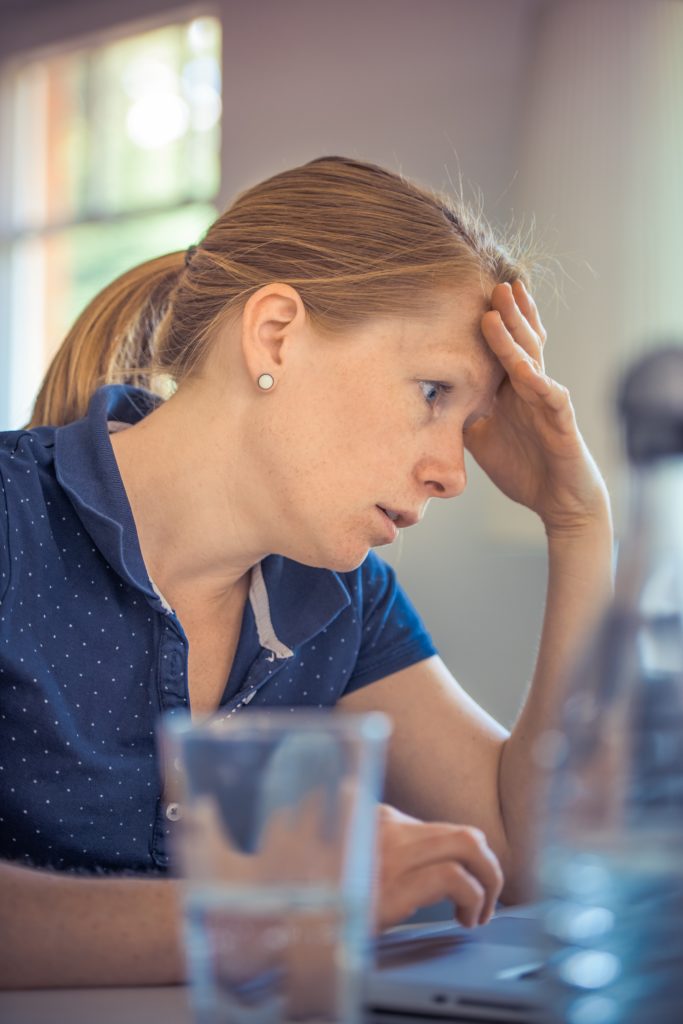 Woman working at computer who appears stressed