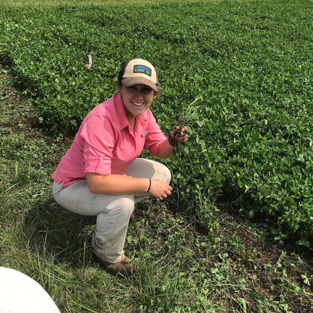 Woman squatting in field