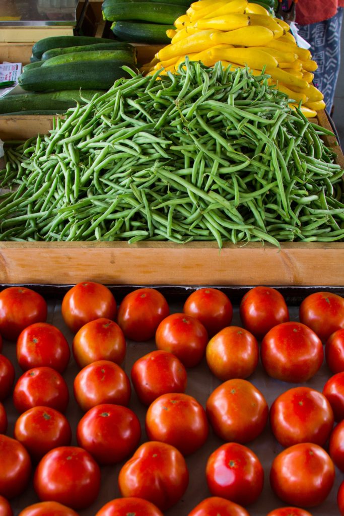Tomatoes, squash and green beans on table at farmers market