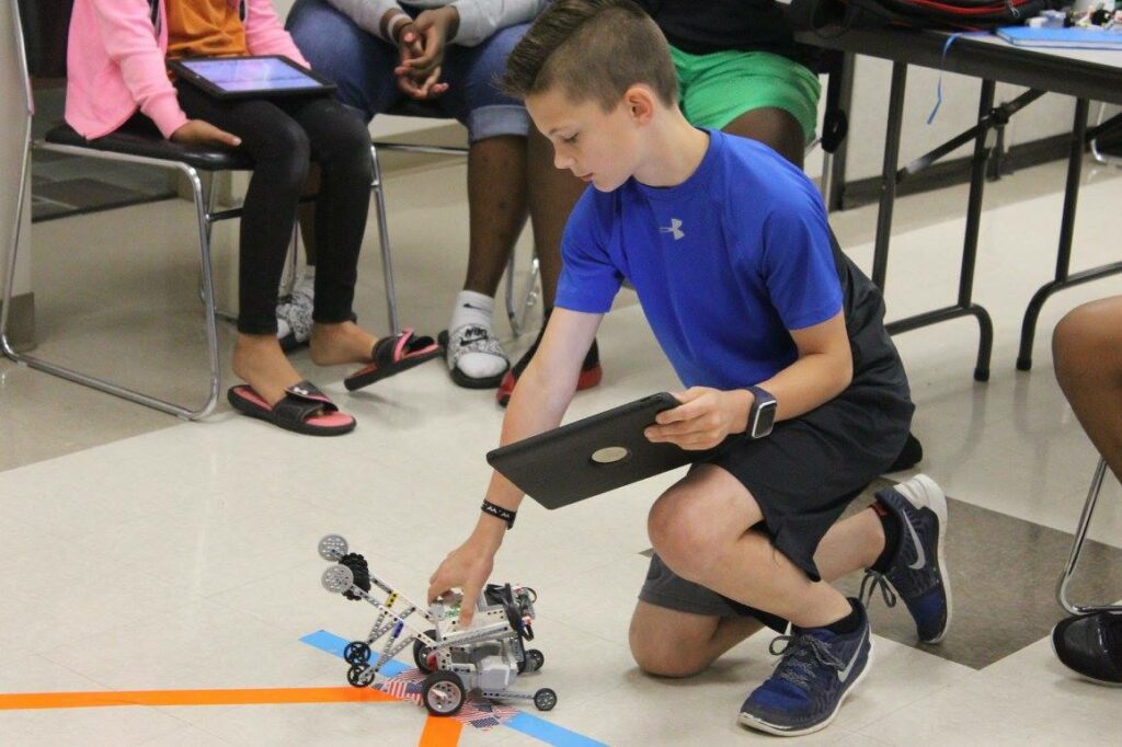 Child Works with Robotics Toy Made