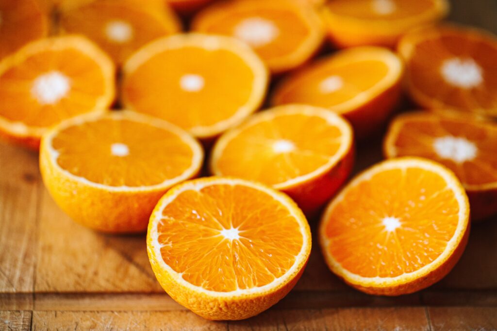 oranges cut into halves on a wooden table