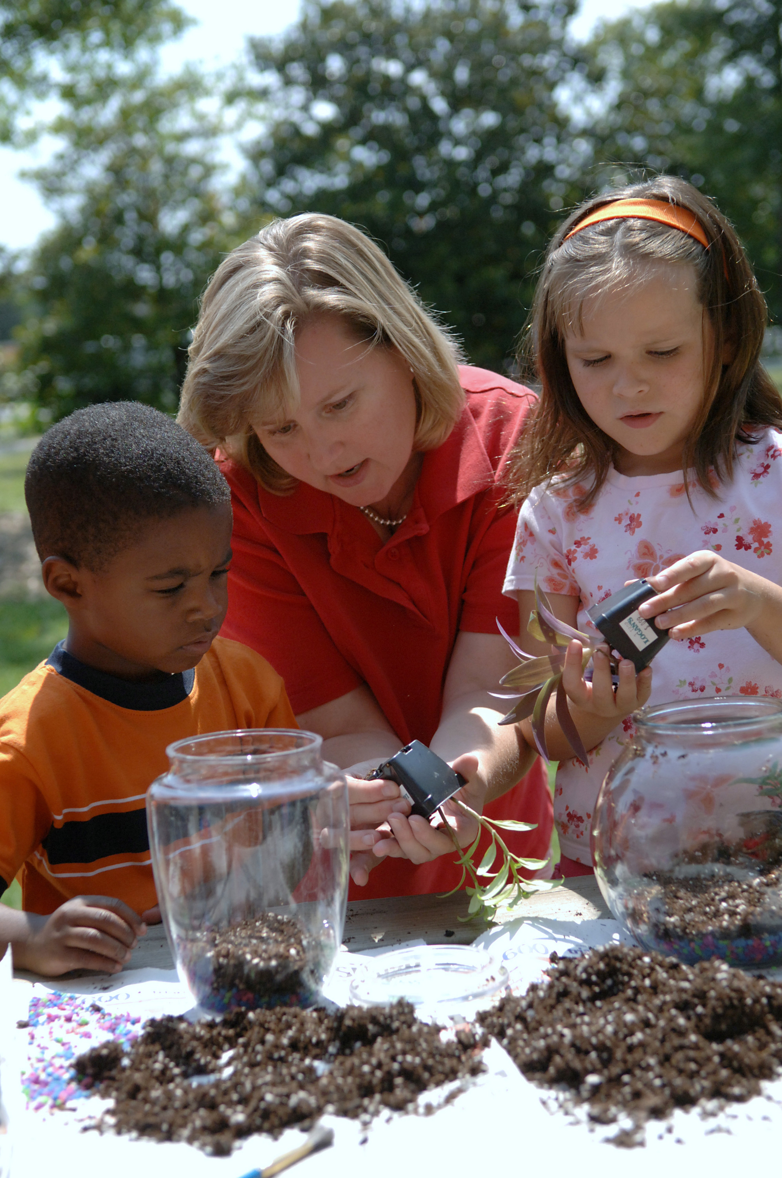 A horticultural agent works with students to make terrariums...Becky Kirkland photos..