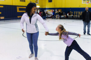 Union County 4-H Summer Intern, Angel, playing with a child in the 4-H program in a gymnasium