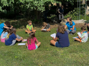 Children sitting in circle learning about animals