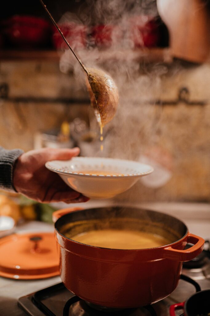 Serving Soup in a bowl from the hot pot on the stove