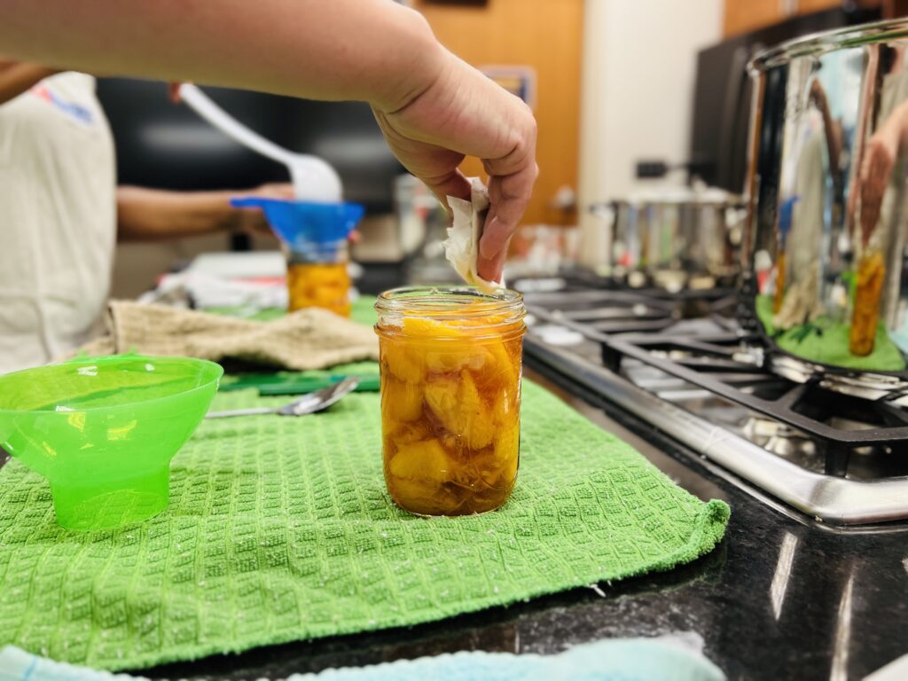 Hand measuring and canning peaches