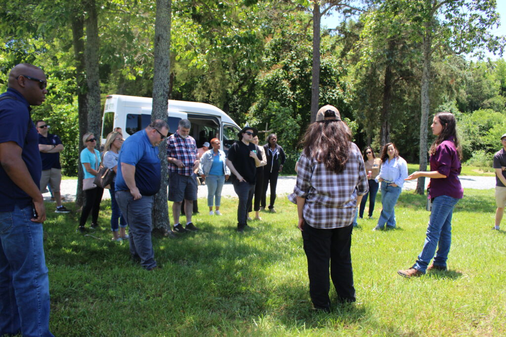 Gena Moore and University student explaining what research is done at the Wingate University Teaching Farm future location. 